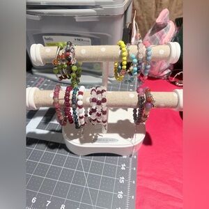 Bracelet and hand display with various bracelets.